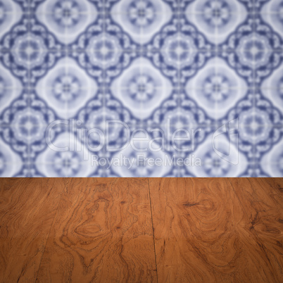 Wood table top and blur vintage ceramic tile pattern wall