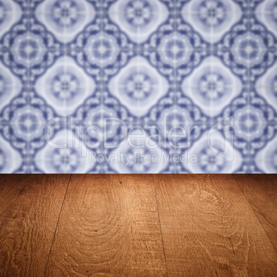 Wood table top and blur vintage ceramic tile pattern wall