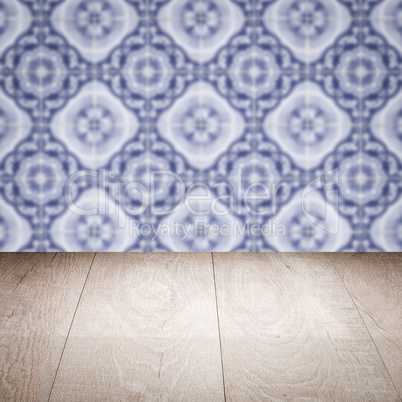 Wood table top and blur vintage ceramic tile pattern wall