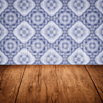 Wood table top and blur vintage ceramic tile pattern wall