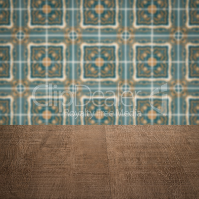 Wood table top and blur vintage ceramic tile pattern wall