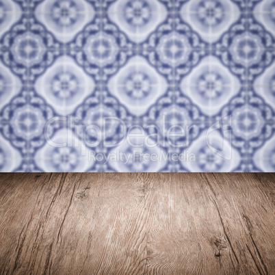 Wood table top and blur vintage ceramic tile pattern wall