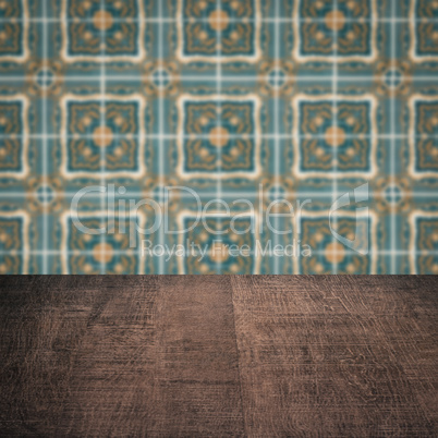 Wood table top and blur vintage ceramic tile pattern wall