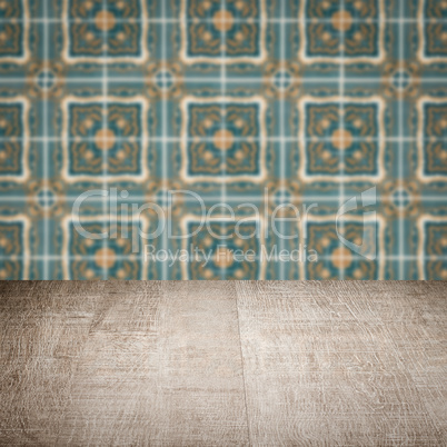 Wood table top and blur vintage ceramic tile pattern wall