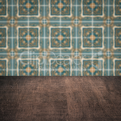 Wood table top and blur vintage ceramic tile pattern wall