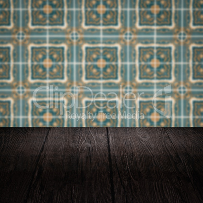 Wood table top and blur vintage ceramic tile pattern wall