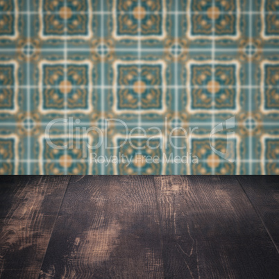 Wood table top and blur vintage ceramic tile pattern wall Wood table top and blur vintage ceramic tile pattern wall