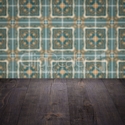 Wood table top and blur vintage ceramic tile pattern wall