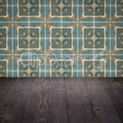 Wood table top and blur vintage ceramic tile pattern wall