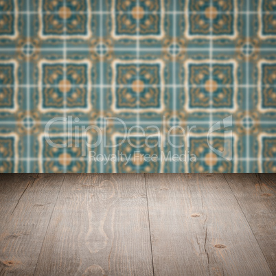 Wood table top and blur vintage ceramic tile pattern wall