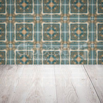 Wood table top and blur vintage ceramic tile pattern wall