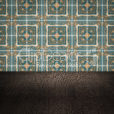 Wood table top and blur vintage ceramic tile pattern wall Wood table top and blur vintage ceramic tile pattern wall