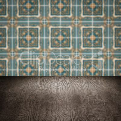 Wood table top and blur vintage ceramic tile pattern wall