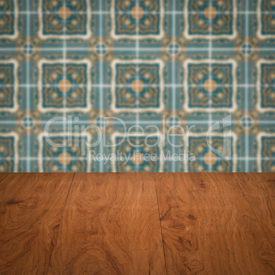 Wood table top and blur vintage ceramic tile pattern wall