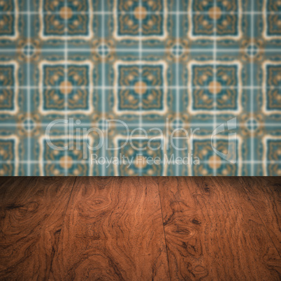 Wood table top and blur vintage ceramic tile pattern wall