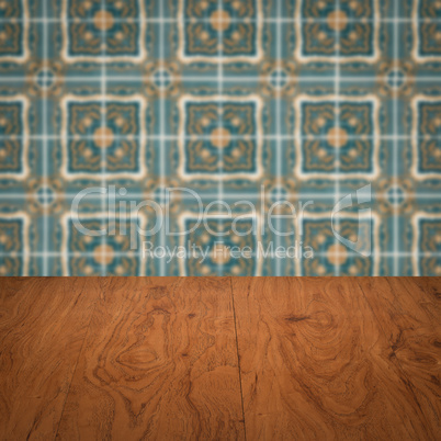 Wood table top and blur vintage ceramic tile pattern wall