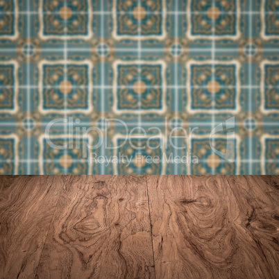 Wood table top and blur vintage ceramic tile pattern wall