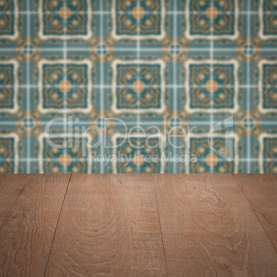 Wood table top and blur vintage ceramic tile pattern wall