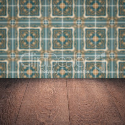 Wood table top and blur vintage ceramic tile pattern wall