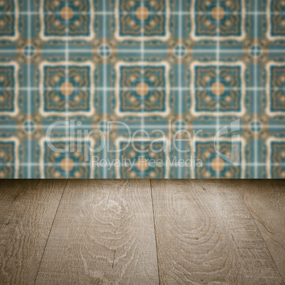 Wood table top and blur vintage ceramic tile pattern wall