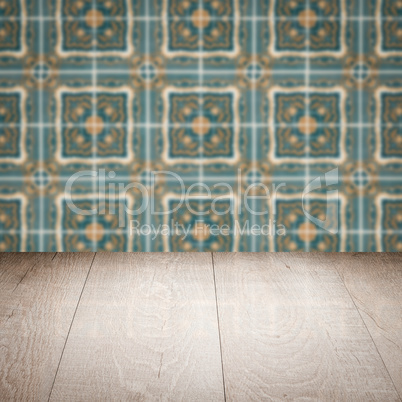 Wood table top and blur vintage ceramic tile pattern wall