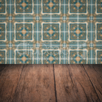 Wood table top and blur vintage ceramic tile pattern wall