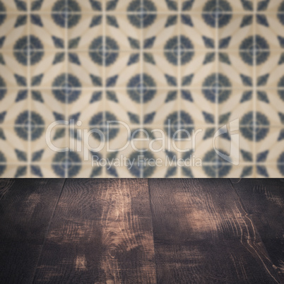 Wood table top and blur vintage ceramic tile pattern wall