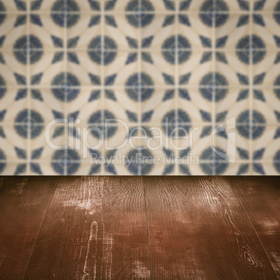 Wood table top and blur vintage ceramic tile pattern wall