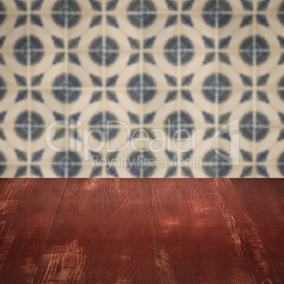 Wood table top and blur vintage ceramic tile pattern wall