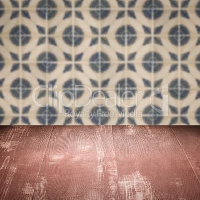 Wood table top and blur vintage ceramic tile pattern wall