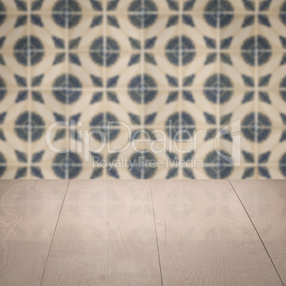 Wood table top and blur vintage ceramic tile pattern wall