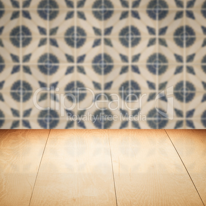 Wood table top and blur vintage ceramic tile pattern wall