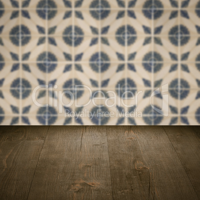 Wood table top and blur vintage ceramic tile pattern wall