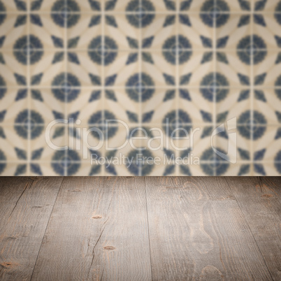 Wood table top and blur vintage ceramic tile pattern wall