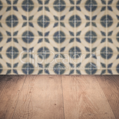 Wood table top and blur vintage ceramic tile pattern wall