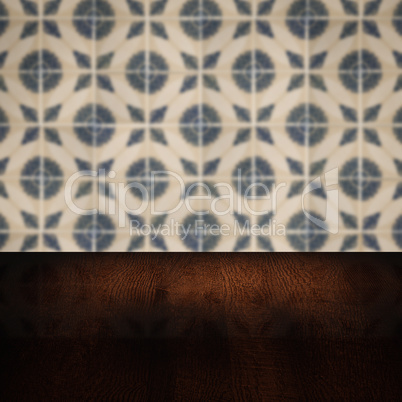 Wood table top and blur vintage ceramic tile pattern wall