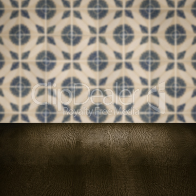 Wood table top and blur vintage ceramic tile pattern wall