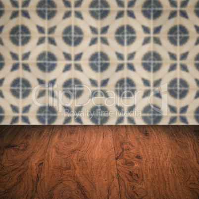 Wood table top and blur vintage ceramic tile pattern wall