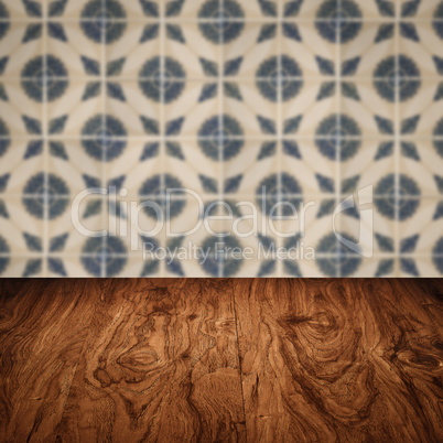 Wood table top and blur vintage ceramic tile pattern wall