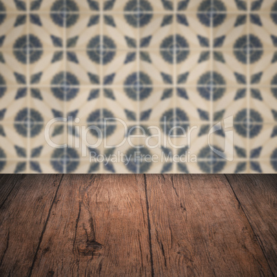 Wood table top and blur vintage ceramic tile pattern wall