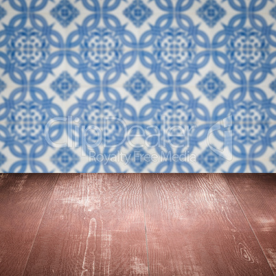 Wood table top and blur vintage ceramic tile pattern wall