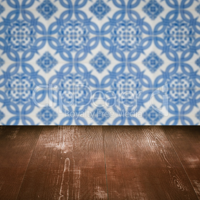 Wood table top and blur vintage ceramic tile pattern wall