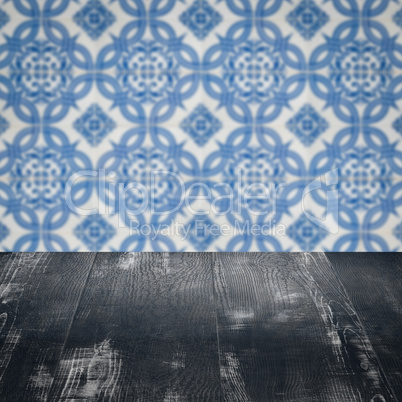 Wood table top and blur vintage ceramic tile pattern wall Wood table top and blur vintage ceramic tile pattern wall