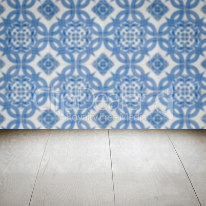 Wood table top and blur vintage ceramic tile pattern wall