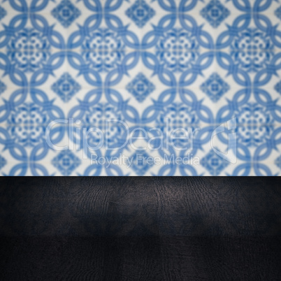 Wood table top and blur vintage ceramic tile pattern wall