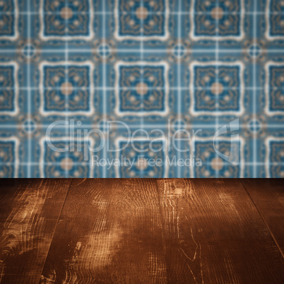 Wood table top and blur vintage ceramic tile pattern wall