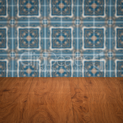 Wood table top and blur vintage ceramic tile pattern wall