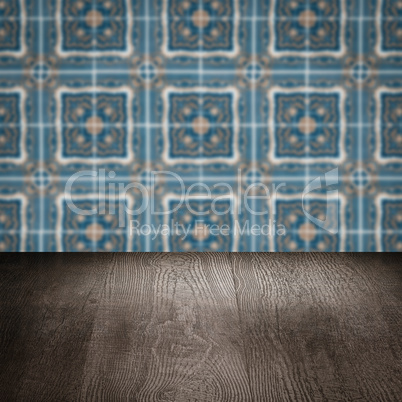 Wood table top and blur vintage ceramic tile pattern wall