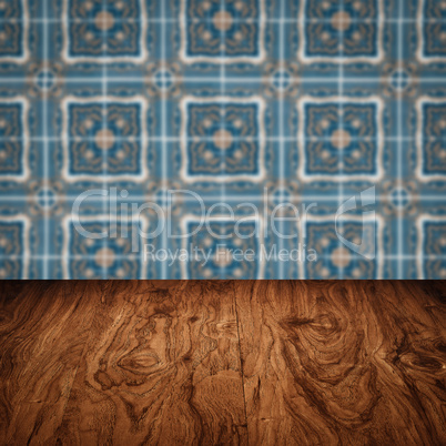 Wood table top and blur vintage ceramic tile pattern wall