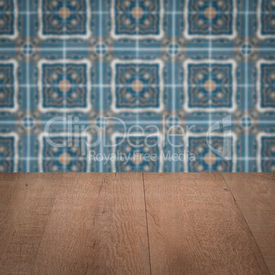 Wood table top and blur vintage ceramic tile pattern wall